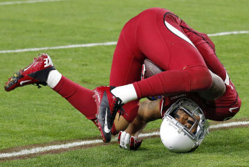 Arizona Cardinals wide receiver Michael Floyd falls after making a catch against the Seattle Seahawks during the second half of an NFL football game, Sunday, Dec. 21, 2014, in Glendale, Ariz. (AP Photo/Ross D. Franklin)