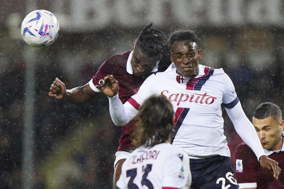 Torino's Duvan Zapata, left, and Bologna's Jhon Lucumi battle for the ball during the Serie A soccer match between Torino and Bologna at the Olympic Stadium Grande Torino, Turin, Italy, Friday May 3, 2024. (Spada/LaPresse via AP)