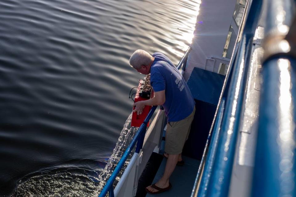 Mark Schick, the senior director of animal operations on the Coral Reef II research vessel owned by Shedd aquarium, dumps water overboard. Ashley Miznazi/amiznazi@miamiherald.com