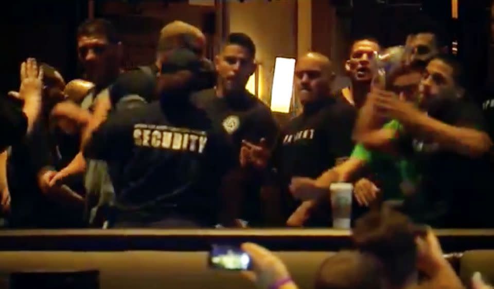 Diaz and his team are seen throwin water bottles at the stage. Photo: Fox