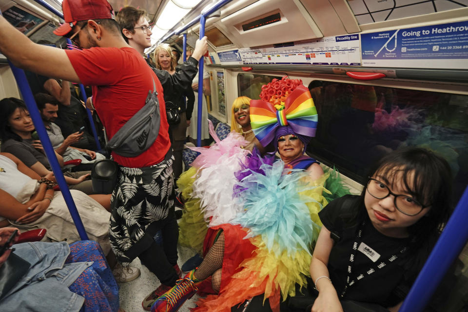 People travel by tube on the London Underground to take part in the Pride in London parade, London, Saturday, July 1, 2023. (Jordan Pettitt/PA via AP)