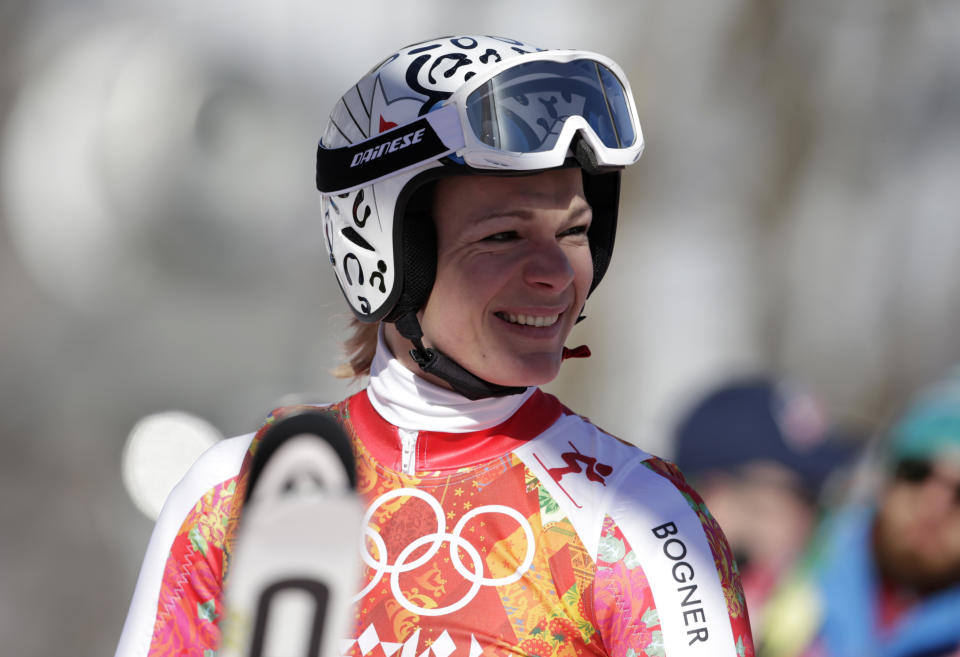 Germany's Maria Hoefl-Riesch smiles in the finish area after a women's downhill training run for the 2014 Winter Olympics, Thursday, Feb. 6, 2014, in Krasnaya Polyana, Russia. (AP Photo/Gero Breloer)