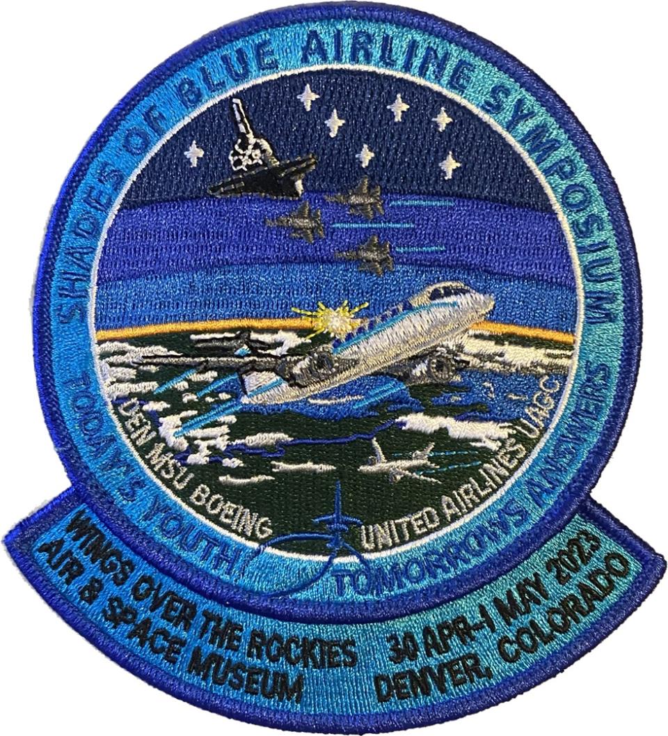 a mission patch with a spacecraft above Earth