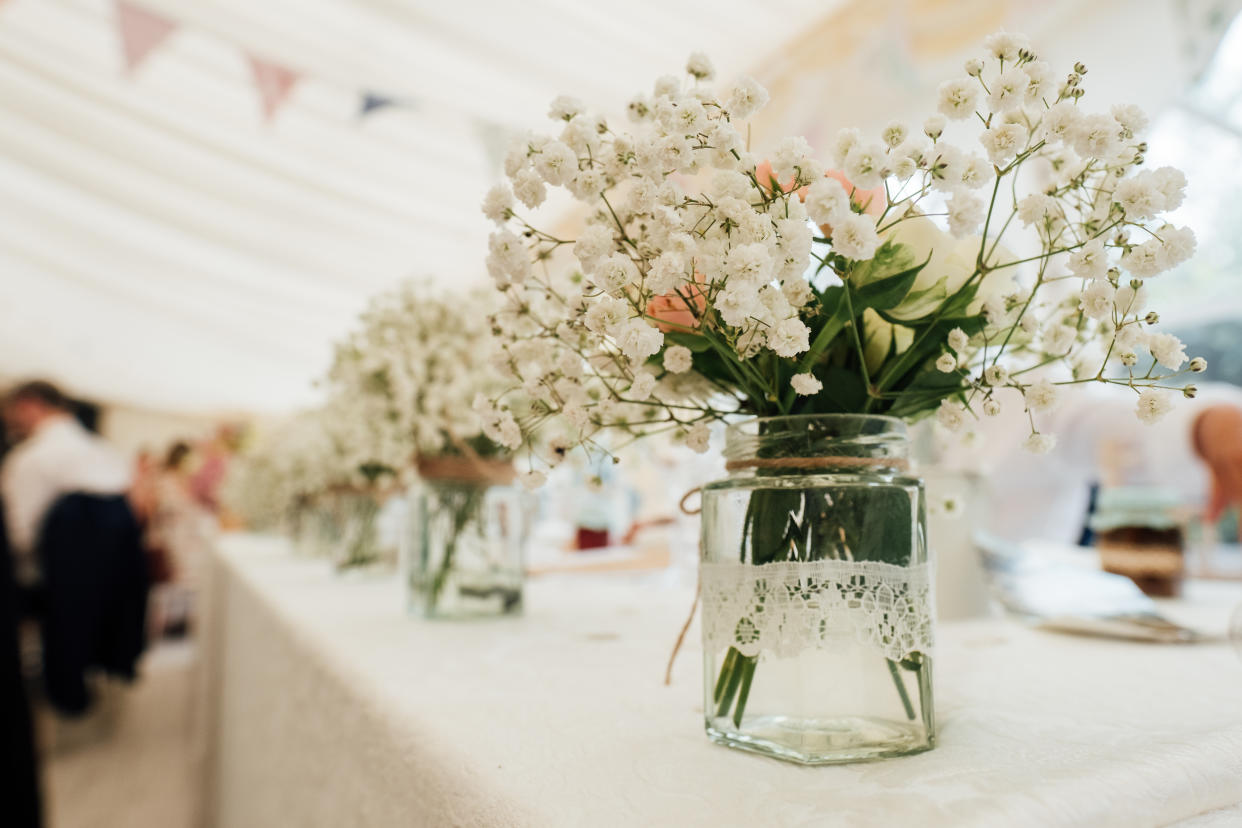 flowers centrepiece and table name with glassware