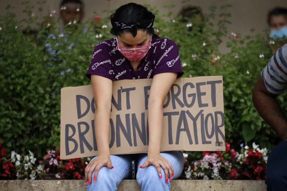 A protester remembering Breonna Taylor listens to speakers at a Black Lives Matter rally in Dallas.