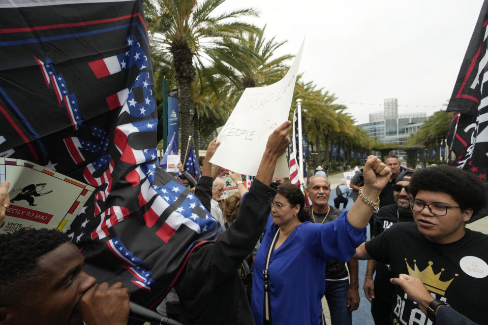 Former President Donald Trump supporters engages with members of Democratic Party of Orange County holding a rally where the 2023 Fall California Republican Convention is being held in Anaheim, Calif., Friday, Sept. 29, 2023. (AP Photo/Damian Dovarganes)