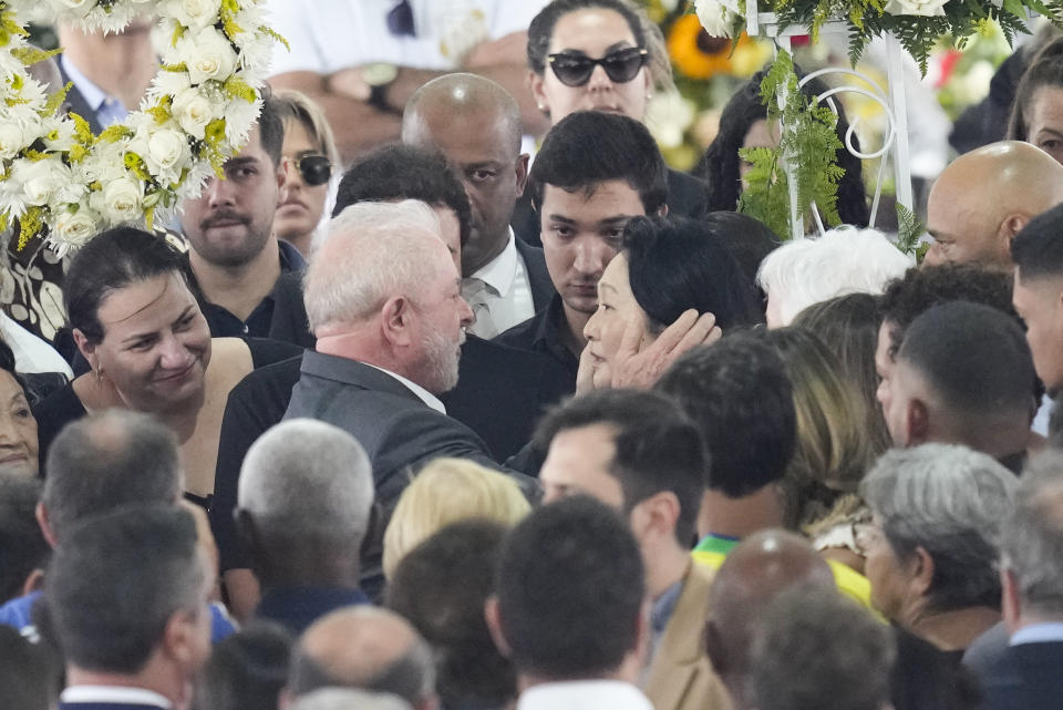 Brazil President Luiz Inacio Lula da Silva, gives condolences to Marcia Aoki, widow of the late Brazilian soccer player Pele, during a wake at Vila Belmiro stadium in Santos, Brazil, Tuesday, Jan. 3, 2023. (AP Photo/Andre Penner)