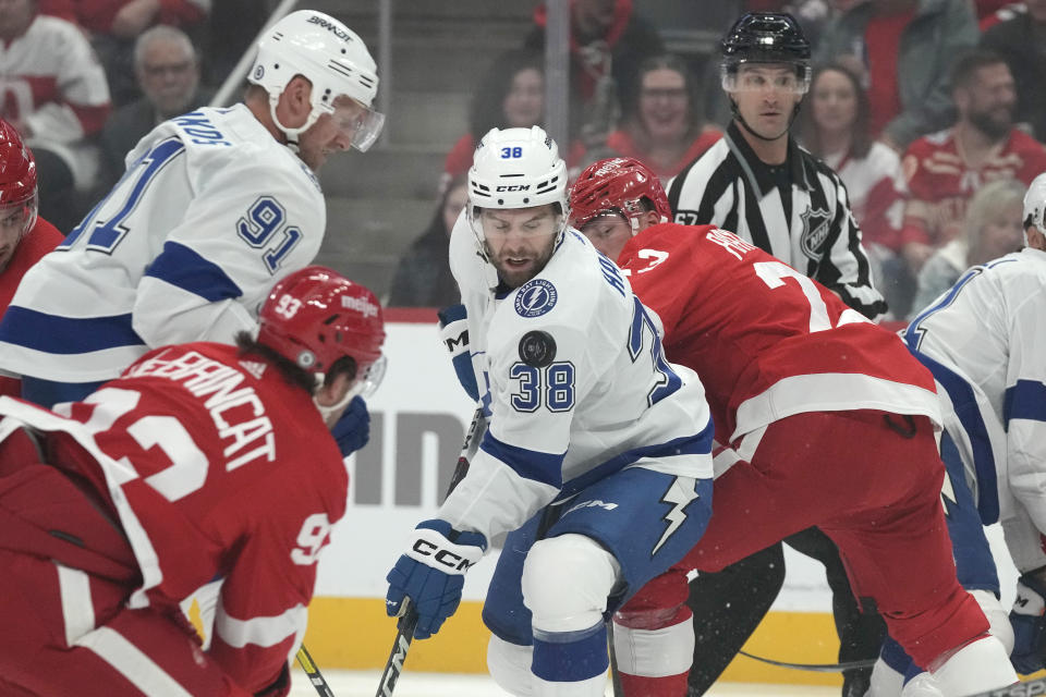 Tampa Bay Lightning left wing Brandon Hagel (38) tries controlling the loose puck during the first period of an NHL hockey game against the Detroit Red Wings, Saturday, Oct. 14, 2023, in Detroit. (AP Photo/Carlos Osorio)
