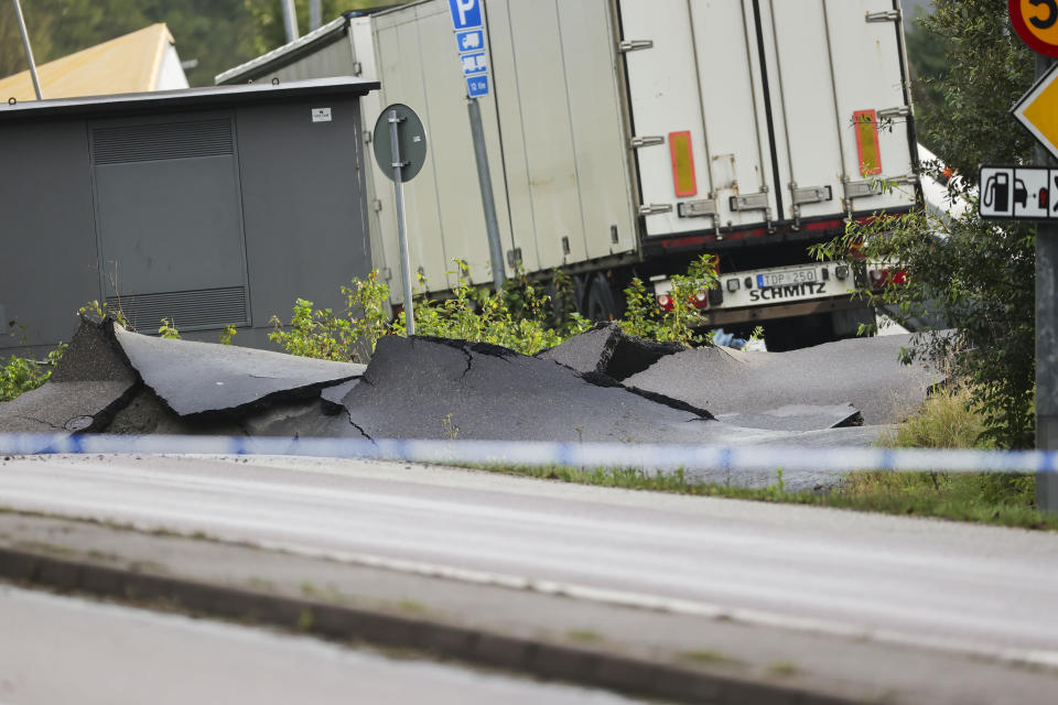 A view of the E6 near Stenungsund, closed in both directions after persistent rain has caused a landslide, in Stenungsund, Saturday, Sept. 23, 2023. Three people have been injured and several buildings and vehicles damaged after a highway collapsed following a landslide in western Sweden early Saturday. Photos and video footage showed a huge sinkhole that had opened on the E6 highway, which runs from southern Sweden to Norway, not far from Sweden’s second largest city of Goteborg. (Adam Ihse/TT News Agency via AP)