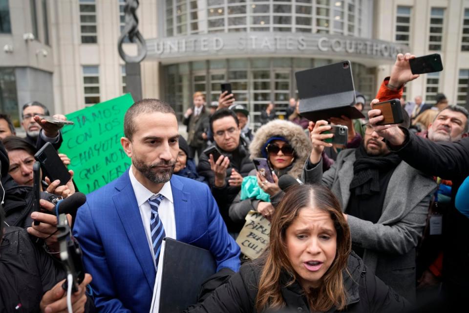 Cesar De Castro, left, attorney for Genaro García Luna prepares to speak to the media after his client was found guilty (AP)