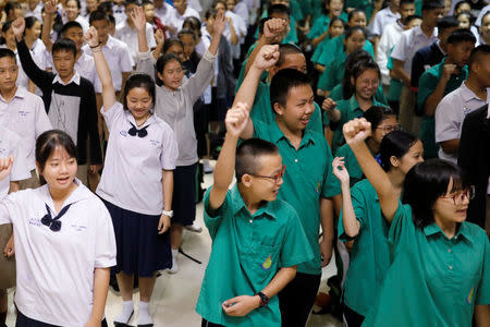 Students of Mae Sai Prasitsart School, where some of the trapped boys study at, celebrate after the 12 soccer players and their coach were rescued from the Tham Luang cave complex, in the northern province of Chiang Rai, Thailand July 11, 2018. REUTERS/Tyrone Siu