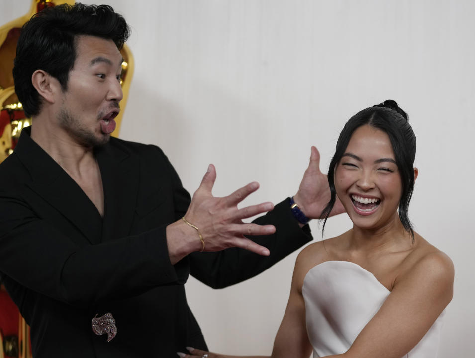 Simu Liu, left, and Allison Hsu arrive at the Oscars on Sunday, March 10, 2024, at the Dolby Theatre in Los Angeles. (AP Photo/Ashley Landis)