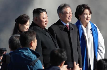 South Korean President Moon Jae-in, first lady Kim Jung-sook, and North Korean leader Kim Jong Un and his wife Ri Sol Ju pose for photographs on the top of Mt. Paektu, North Korea, September 20, 2018. Pyeongyang Press Corps/Pool via REUTERS