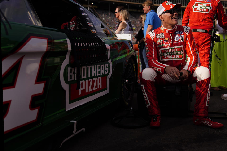 Kevin Harvick (4) sits beside his car before a NASCAR Cup Series auto race at Atlanta Motor Speedway on Sunday, July 9, 2023, in Hampton, Ga. (AP Photo/Brynn Anderson)