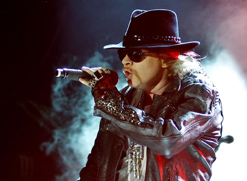 FILE - This Dec. 7, 2012 file photo shows Axl Rose, lead vocalist of Guns N' Roses performing during their concert in Bangalore, India. Rose will receive the Ronnie James Dio Lifetime Achievement Award at the Revolver Golden Gods Awards for hard rock on April 23 at the Club Nokia in Los Angeles. (AP Photo/Aijaz Rahi, file)