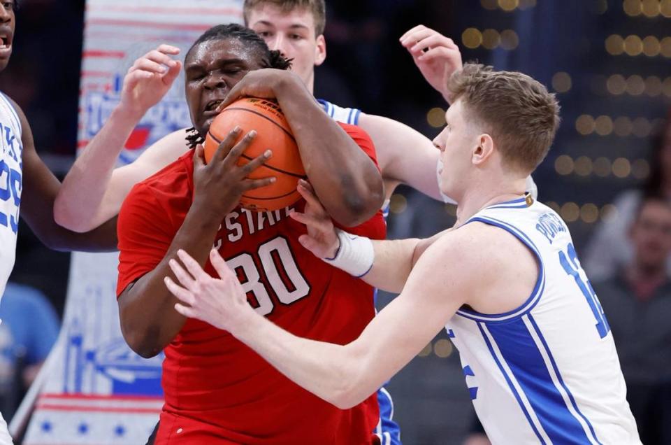 N.C. State’s DJ Burns Jr. (30) keeps the ball from Duke’s TJ Power (12) during the first half of N.C. State’s game against Duke in the quarterfinal round of the 2024 ACC Men’s Basketball Tournament at Capital One Arena in Washington, D.C., Thursday, March 14, 2024. Ethan Hyman/ehyman@newsobserver.com