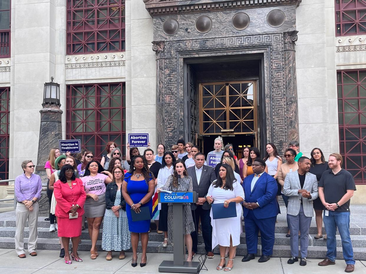 City Councilmember Elizabeth Brown, center, flanked by fellow women's caucus members Shayla Favor on the left and Lourdes Barroso de Padilla on the right, speaks at a news conference Friday during which they announced a proposal to support reproductive rights in Columbus.