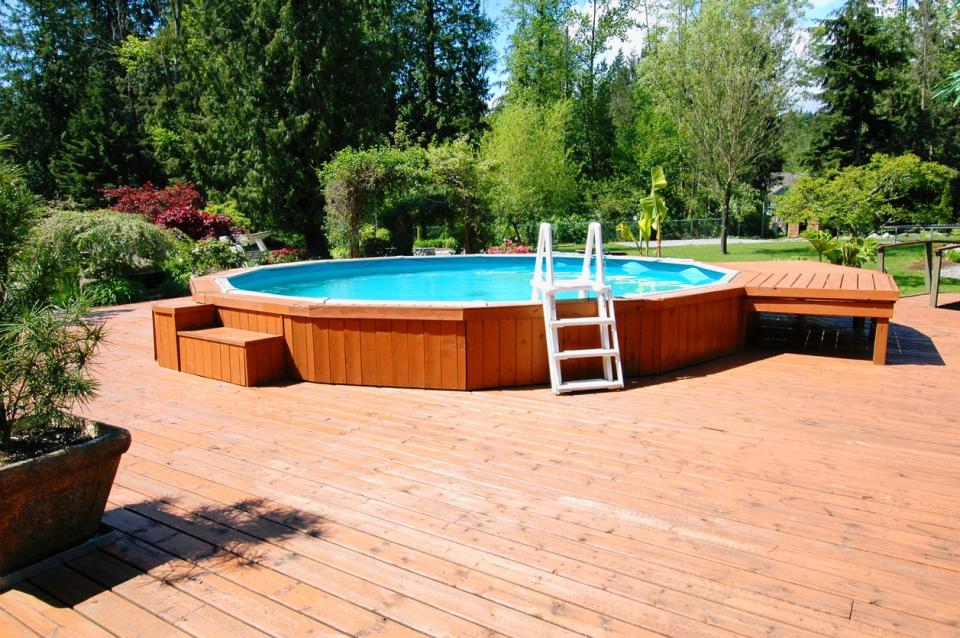 Above-ground pool built into a wooden deck