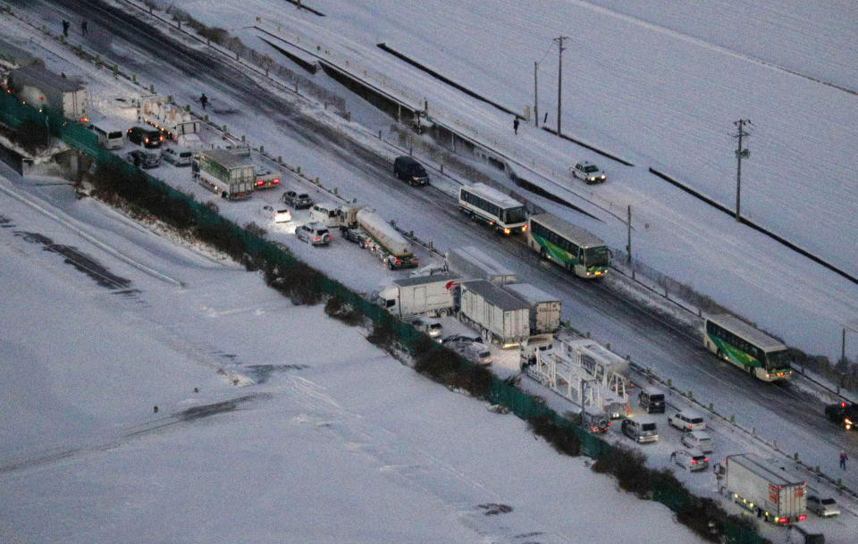 Cars are stuck on the snowy Tohoku Expressway in Osaki city, Miyagi prefecture, northern Japan, after a multiple car accident, Tuesday, Jan. 19. 2021. (Yuta Omori/Kyodo News via AP)