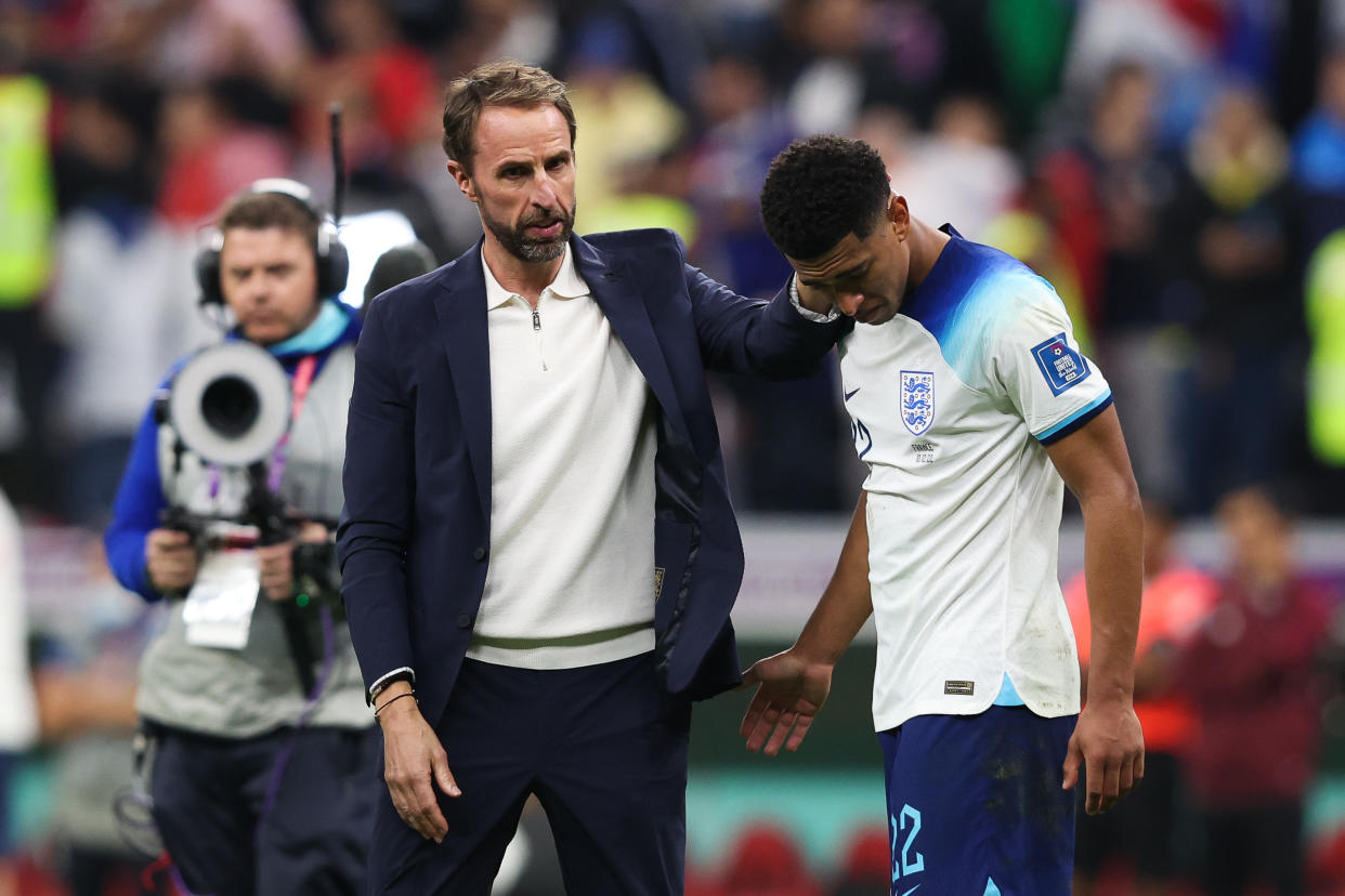 England midfielder Jude Bellingham (right) is consoled by manager Gareth Southgate after the 2022 World Cup quarter-final clash against France.