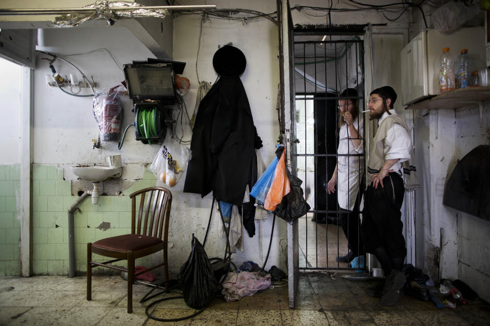 Ultra-Orthodox Jews smoke a cigarette as they take break during baking of special matzoh, a traditional handmade Passover unleavened bread, at a bakery in Bnei Brak near Tel Aviv, Israel. Thursday, April 10, 2014. Jews are forbidden to eat leavened foodstuffs during the Passover holiday. Passover celebrates the biblical story of the Israelites' escape from slavery and exodus from Egypt. (AP Photo/Oded Balilty)