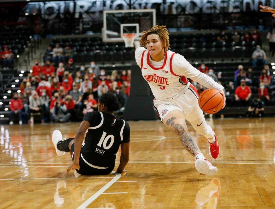 Ohio State guard Kateri Poole drives past Cincinnati forward Jadyn Scott.