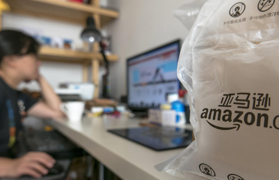 A Chinese girl is buying goods from Amazon.cn. (Photo by Zhang Peng/LightRocket via Getty Images)