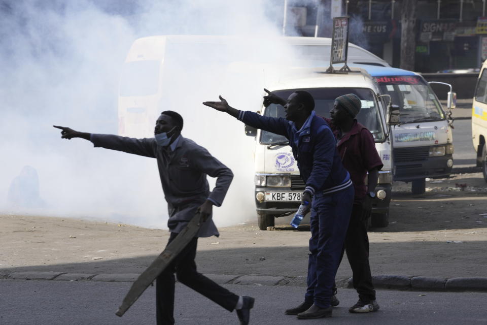 Members of the public call for reinforcement as protesters set vehicles on fire in downtown Nairobi, Kenya Tuesday, July 2, 2024. Protests have continued to rock several towns in Kenya including the capital Nairobi, despite the president saying he will not sign a controversial finance bill that sparked deadly protests last week. (AP Photo/Brian Inganga)