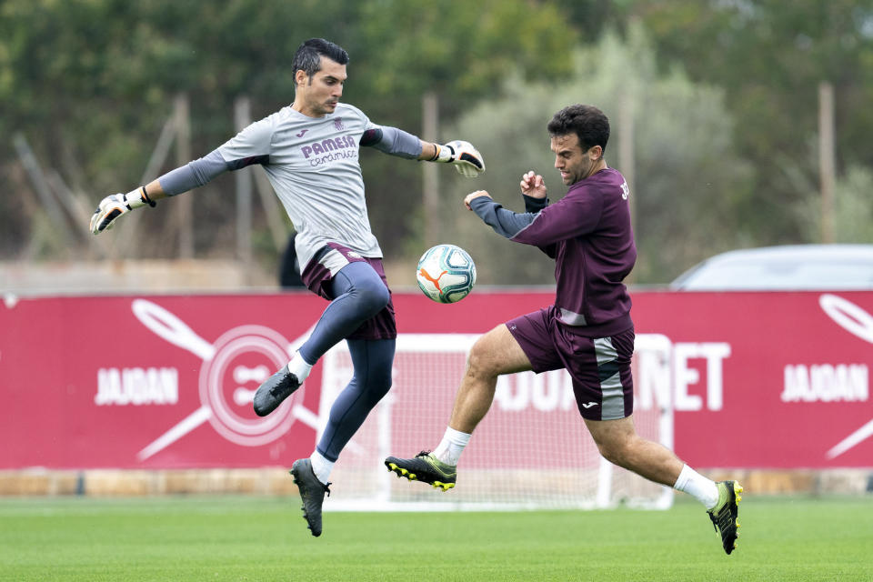 In this photo released by Villarreal Club de Futbol on Tuesday, Oct. 15, 2019, Giuseppe Rossi, right, duels for the ball during a training with Spanish club Villarreal, Spain. Rossi, the American-born striker who played for the Italian national team before a series of injuries slowed his career, is back at Villarreal, the Spanish club where he thrived in his prime. (Villareal F.C via AP)