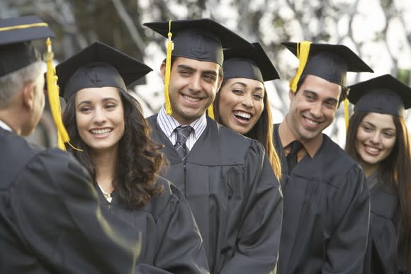 Group of young adults in graduation clothing.