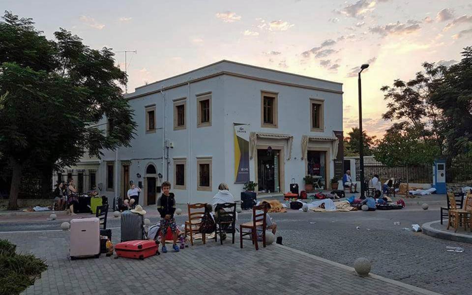 Residents sleep in a public square following a strong earthquake on the Greek island of Kos  - Credit: AP