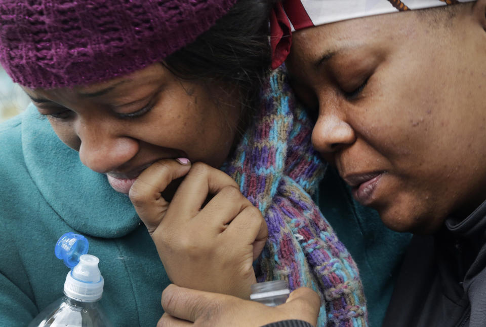 Alecia Thomas, left, is comforted by her friend, Shivon Dollar, after she lost her home following an explosion that leveled two apartment buildings in the East Harlem neighborhood of New York, Wednesday, March 12, 2014. Con Edison spokesman Bob McGee says a resident from a building adjacent to the two that collapsed reported that he smelled gas inside his apartment, but thought the odor could be coming from outside. (AP Photo/Mark Lennihan)