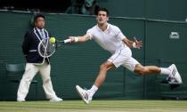 Novak Djokovic of Serbia hits a return during his men's singles final tennis match against Roger Federer of Switzerland at the Wimbledon Tennis Championships, in London July 6, 2014. REUTERS/Stefan Wermuth