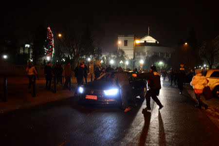 FILE PHOTO: Protesters try to block the exit of the Polish Parliament in Warsaw December 17, 2016. Agencja Gazeta/Michal Jazwiecki/via Reuters/File Photo