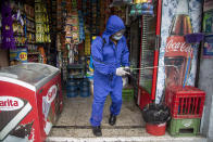 A health worker sprays disinfectant to sanitize a grocery store amid the new coronavirus pandemic in Quetzaltenango, Guatemala, Saturday, Aug. 8, 2020. (AP Photo/Moises Castillo)