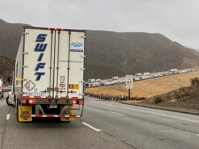 California Highway Patrol officials diverted trucks stuck on southbound Interstate 5 after an overturned big rig closed southbound lanes along the Grapevine near Vista Del Lago Road on Tuesday.