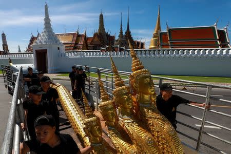 Workers move deity sculptures which will be used in the Royal Crematorium for the late King Bhumibol Adulyadej in Bangkok, Thailand, September 19, 2017. REUTERS/Athit Perawongmetha