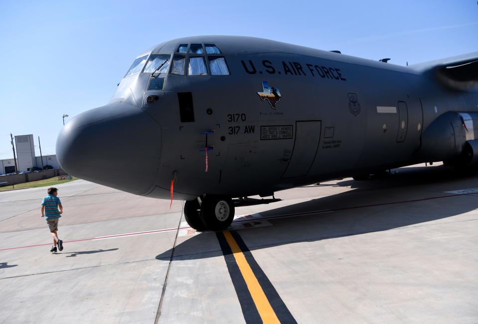 A young visitor walks past a C-130 as he admires the aircraft after a ceremony at Dyess Air Force Base in 2018.