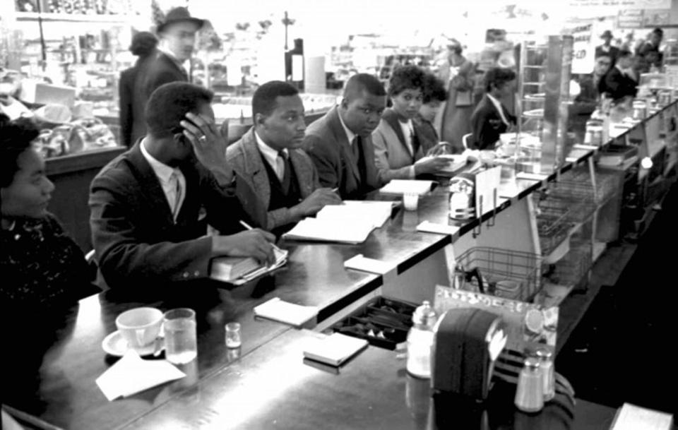 Aaron Johnson with other students from Shaw University in 1960 as they protest at a Woolworth's lunch counter in Raleigh. Photo is from the North Carolina State Archives. Church members with Mt. Sinai Missionary Baptist Church will celebrate Johnson, who is pastor emeritus, for Black History Month on Sunday, Feb. 25, 2024.
