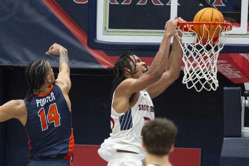 Saint Mary's forward Mason Forbes dunks in front of Pepperdine forward Jevon Porter (14) during the second half of an NCAA college basketball game Thursday, Feb. 15, 2024, in Moraga, Calif. (AP Photo/D. Ross Cameron)