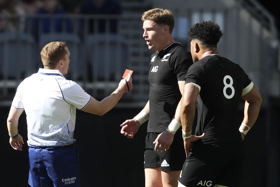 Referee Damon Murphy shows a red card to New Zealand's Jordie Barrett, centre, as his captain Ardie Savea watches during the Rugby Championship game between the All Blacks and the Wallabies in Perth, Australia, Sunday, Sept. 5, 2021. (AP Photo/Gary Day)