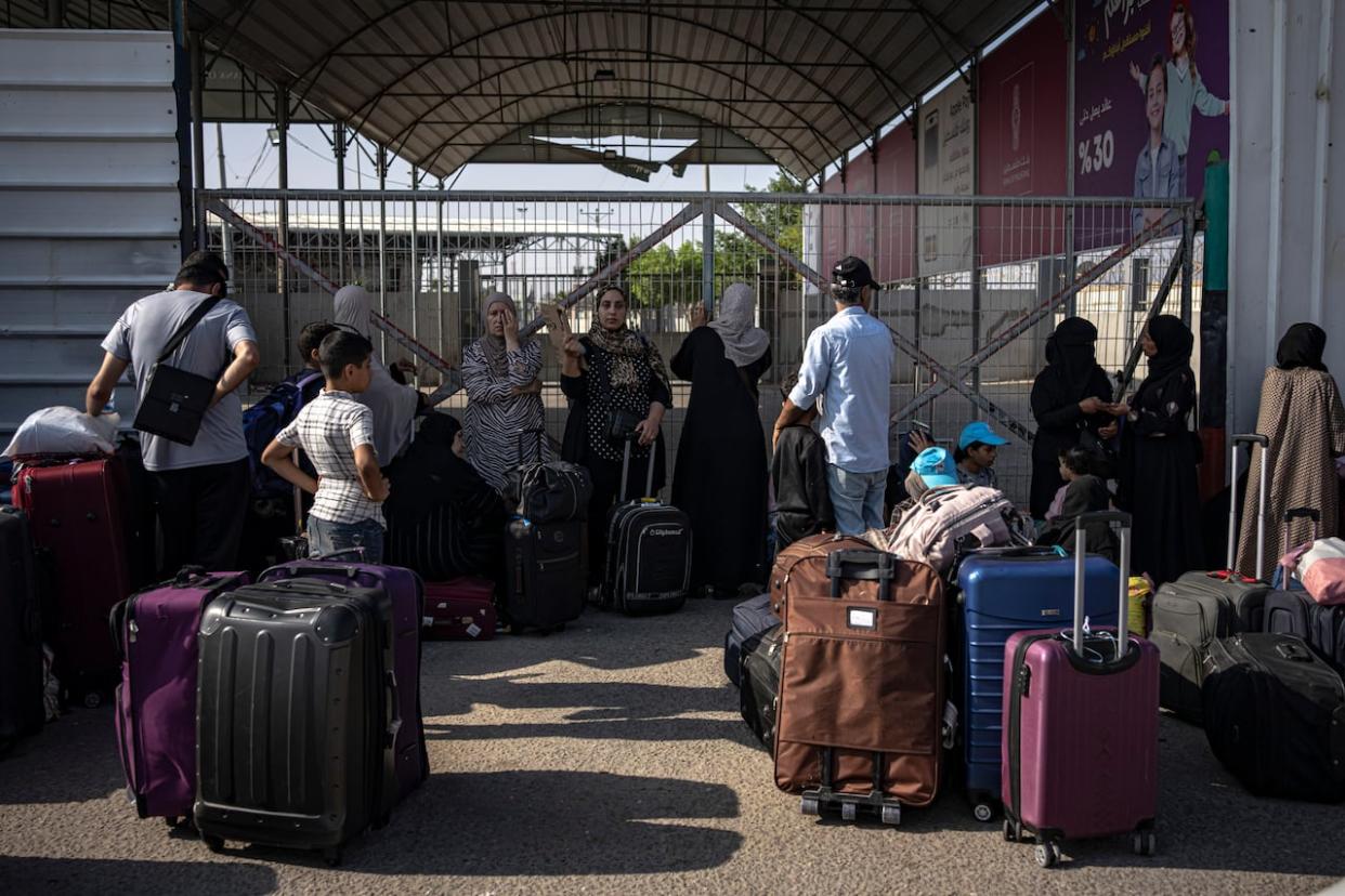 Palestinians wait to cross into Egypt at Rafah, Gaza Strip, on Wednesday, Nov. 1, 2023. (Fatima Shbair/The Canadian Press/AP - image credit)