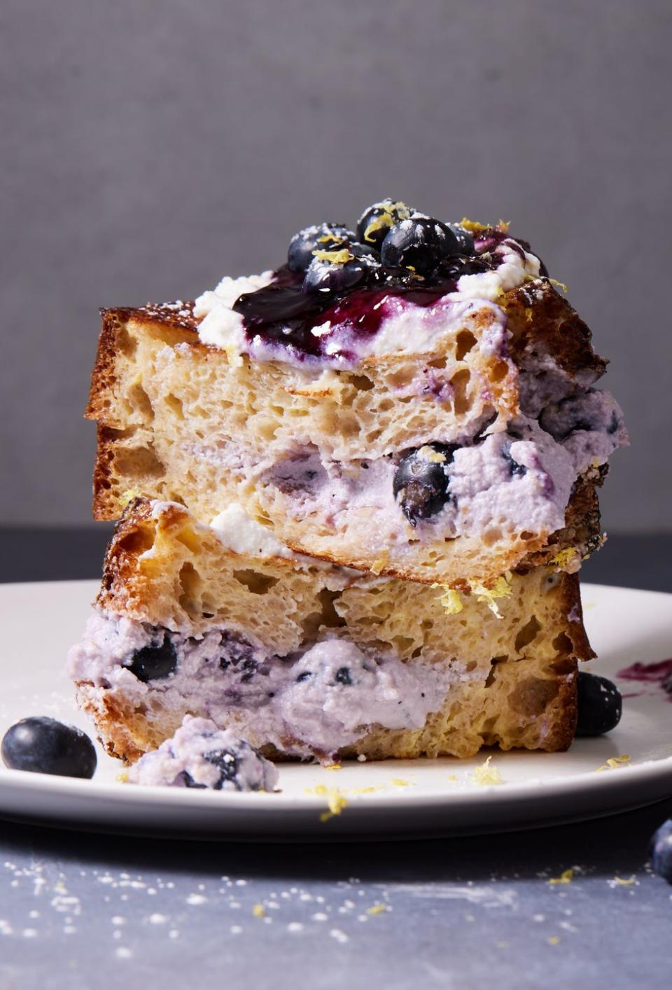 <p>Stuffed with a rich, lilac-colored blueberry <a href="https://www.delish.com/cooking/recipe-ideas/a32937529/homemade-ricotta-recipe/" rel="nofollow noopener" target="_blank" data-ylk="slk:ricotta;elm:context_link;itc:0;sec:content-canvas" class="link ">ricotta</a>, this <a href="https://www.delish.com/cooking/recipe-ideas/g2973/50-most-delish-french-toasts/" rel="nofollow noopener" target="_blank" data-ylk="slk:French toast;elm:context_link;itc:0;sec:content-canvas" class="link ">French toast </a>exactly what we crave when we’re dreaming of a sweet breakfast to go with our morning coffee. Sourdough is our bread of choice because it’s sturdy, and its earthy tang is a nice foil to the rich filling. That said, if you love <a href="https://www.delish.com/cooking/recipe-ideas/a28848483/brioche-bread-recipe/" rel="nofollow noopener" target="_blank" data-ylk="slk:brioche;elm:context_link;itc:0;sec:content-canvas" class="link ">brioche</a> or <a href="https://www.delish.com/cooking/recipe-ideas/a32502247/challah-bread-recipe/" rel="nofollow noopener" target="_blank" data-ylk="slk:challah;elm:context_link;itc:0;sec:content-canvas" class="link ">challah</a> French toast, feel free to experiment with those instead.<br><br>Get the <strong><a href="https://www.delish.com/cooking/recipe-ideas/a39863465/blueberry-lemon-ricotta-stuffed-french-toast-recipe/" rel="nofollow noopener" target="_blank" data-ylk="slk:Blueberry-Lemon Ricotta Stuffed French Toast recipe;elm:context_link;itc:0;sec:content-canvas" class="link ">Blueberry-Lemon Ricotta Stuffed French Toast recipe</a></strong>.</p>
