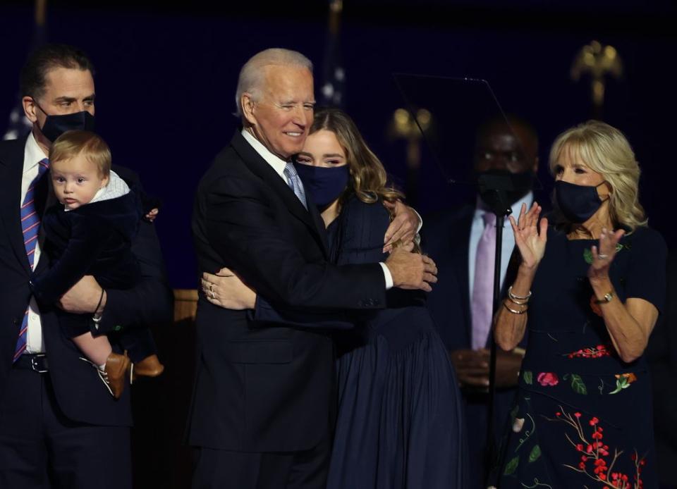 President-elect Joe Biden hugs his grandchild on stage after Biden’s address to the nation from the Chase Center November 07, 2020 in Wilmington, Delaware. After four days of counting the high volume of mail-in ballots in key battleground states due to the coronavirus pandemic, the race was called for Biden after a contentious election battle against incumbent Republican President Donald Trump. (Photo by Tasos Katopodis/Getty Images)