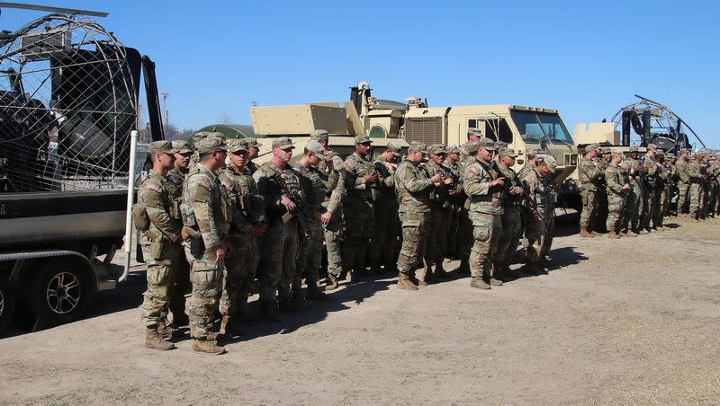 Texas National Guard members stand in the background before a press conference on Sunday, Feb. 4, 2024, in Eagle Pass, Texas, with governors from 14 states including Utah Gov. Spencer Cox.