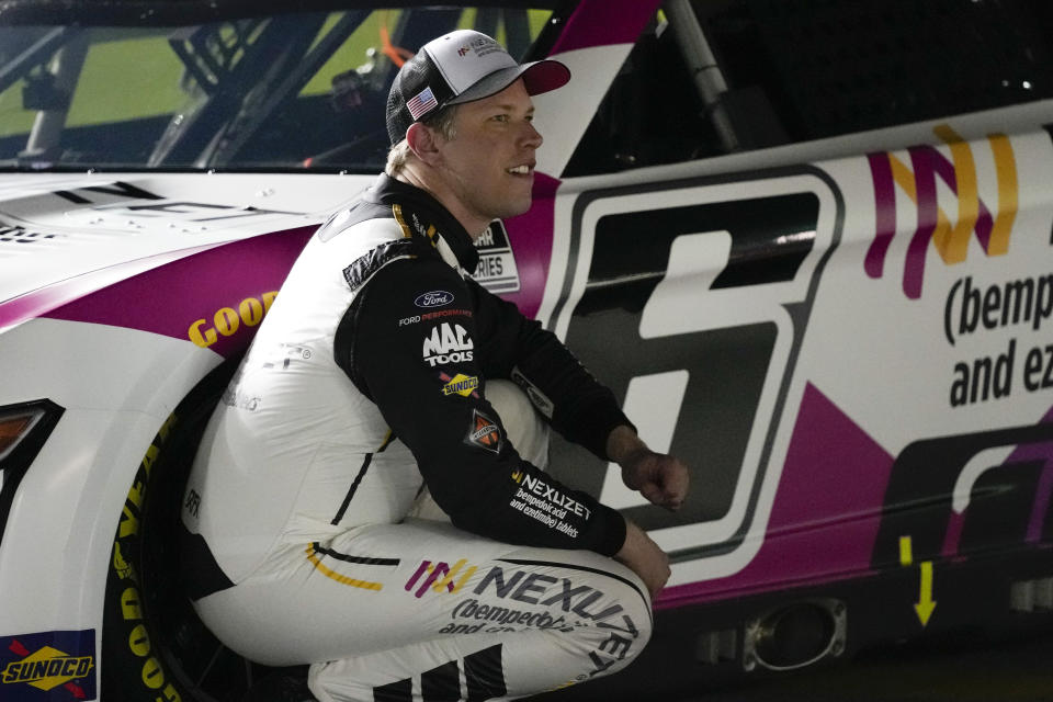 Brad Keselowski kneels next to his car after his qualifying run for the NASCAR Daytona 500 auto race at Daytona International Speedway, Wednesday, Feb. 15, 2023, in Daytona Beach, Fla. (AP Photo/John Raoux)