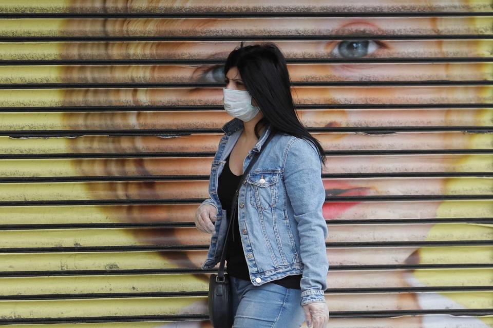 A woman wears a mask in London (AP)