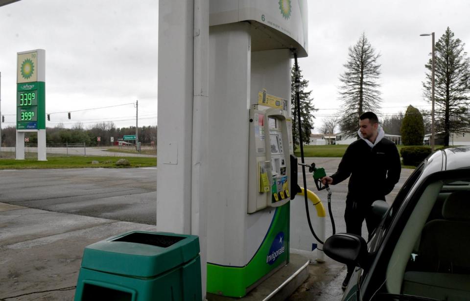 PHOTO: Nathan Davis of Doylestown puts gas in his car at Doylestown Food Mart, March 26, 2024. (Julie Vennitti Botos / Canton Repository /USA Today)