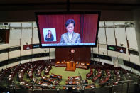 A TV screen shows Hong Kong Chief Executive Carrie Lam delivering her policies at chamber of the Legislative Council in Hong Kong, Wednesday, Nov. 25, 2020. Lam said Wednesday that the city's new national security law has been “remarkably effective in restoring stability” after months of political unrest, and that bringing normalcy back to the political system is an urgent priority. (AP Photo/Kin Cheung)