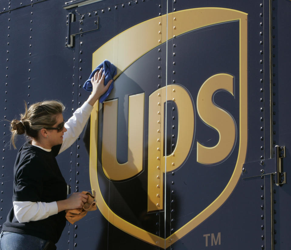 FILE - In a Jan. 25, 2007 file photo Brandy Goggin polishes a UPS sign on a UPS truck in New Orleans. United Parcel Service Inc. said Monday March 19, 2012, it has agreed to buy TNT Express NV for $6.77 billion (€5.16 billion). (AP Photo/Bill Haber/file)